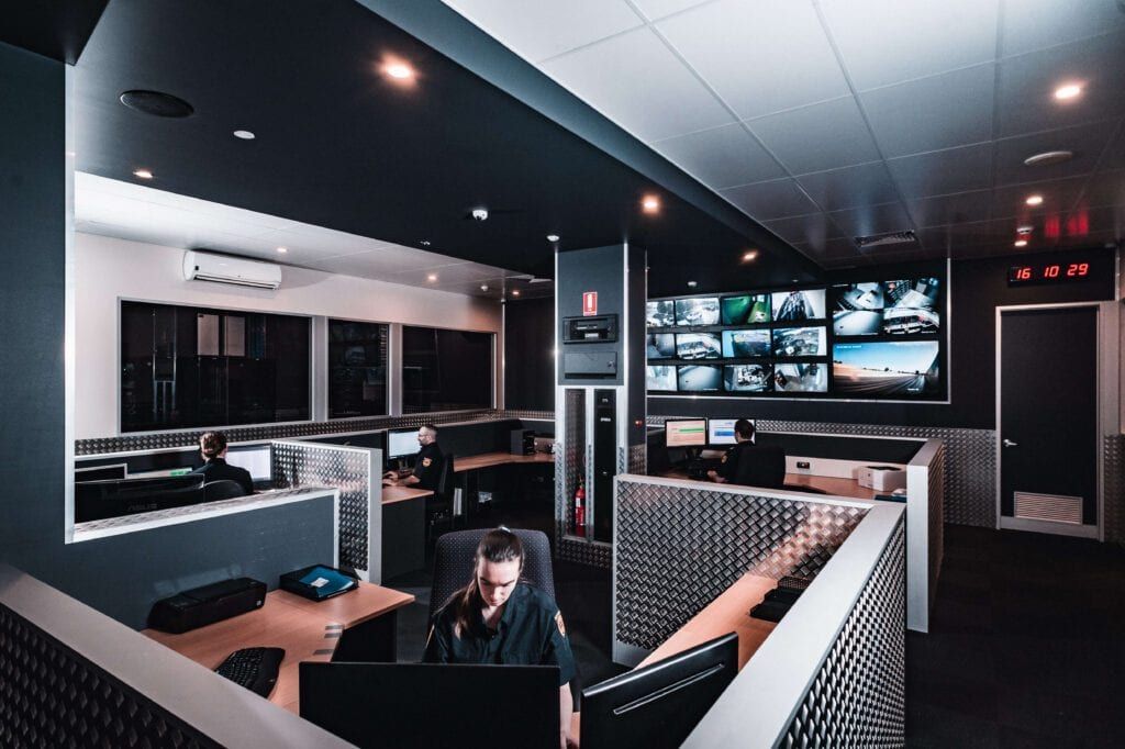 The control room floor, with camera feeds on the video wall